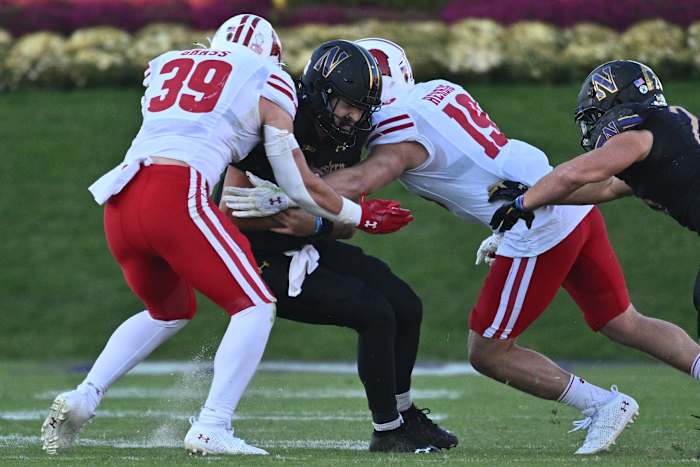 Wisconsin linebacker Tate Grass and Nick Herbig combining for a tackle against Northwestern.